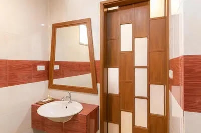 a bathroom with a sink and a mirror at Lotus Hotel Patong in Patong Beach