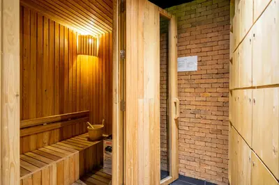 an empty wooden sauna with a brick wall at Mountain View Apartment - Bangtao in Kathu