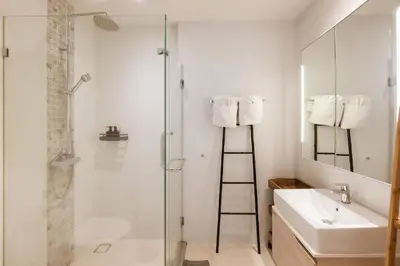 a bathroom with a shower and a sink and a mirror at Mountain View Apartment - Bangtao in Kathu