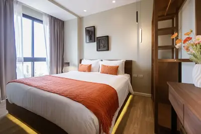 a hotel room with a large bed and a window at Mountain View Apartment - Bangtao in Kathu