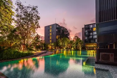 a large swimming pool in a city at dusk at The deck patong 5 Star Apartment \u5df4\u4e1cThe Deck\u65e0\u8fb9\u9645\u6d77\u666f\u6cf3\u6c60\u9152\u5e97 in Patong Beach