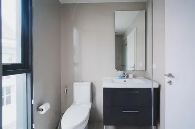 a bathroom with a toilet and a sink and a mirror at The deck patong 5 Star Apartment \u5df4\u4e1cThe Deck\u65e0\u8fb9\u9645\u6d77\u666f\u6cf3\u6c60\u9152\u5e97 in Patong Beach
