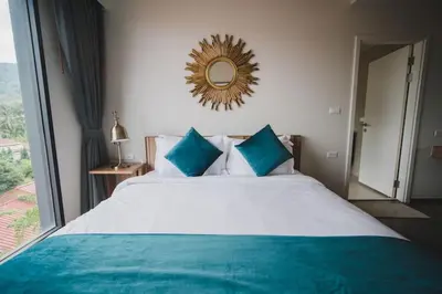 a bedroom with a large bed with a mirror on the wall at The deck patong 5 Star Apartment \u5df4\u4e1cThe Deck\u65e0\u8fb9\u9645\u6d77\u666f\u6cf3\u6c60\u9152\u5e97 in Patong Beach