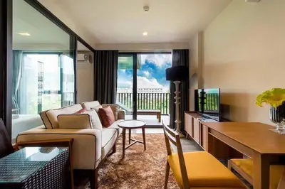 a living room with a couch and a tv at The deck patong 5 Star Apartment \u5df4\u4e1cThe Deck\u65e0\u8fb9\u9645\u6d77\u666f\u6cf3\u6c60\u9152\u5e97 in Patong Beach