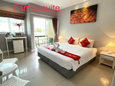 a bedroom with a large white bed in a room at Thalassa Kata Beach in Kata Beach