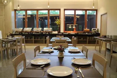 a dining room with tables and chairs and a piano at CA Hotel and Residence Phuket - SHA Extra Plus in Phuket Town