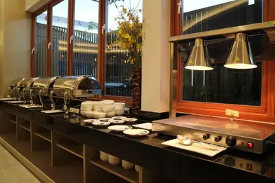 a kitchen with a counter with dishes on it at CA Hotel and Residence Phuket - SHA Extra Plus in Phuket Town