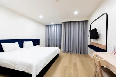 a hotel room with a bed and a tv at CA Hotel and Residence Phuket - SHA Extra Plus in Phuket Town