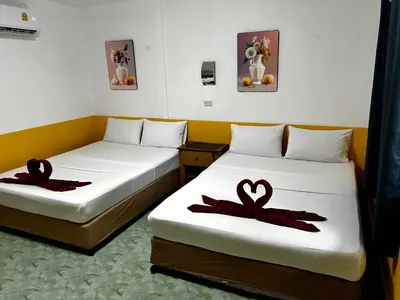 a room with two beds with red bows on them at Coco's Guest House in Phi Phi Don