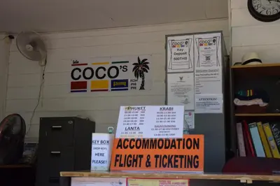 a room with signs on the wall and a desk at Coco's Guest House in Phi Phi Don