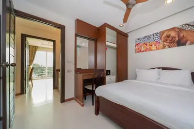 a bedroom with a bed and a desk in it at Sea and Sky Condominium by Lofty in Karon Beach