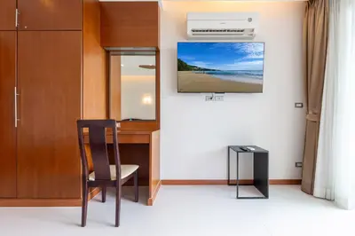 a room with a desk and a chair and a picture at Sea and Sky Condominium by Lofty in Karon Beach