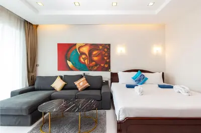 a living room with two beds and a couch at Sea and Sky Condominium by Lofty in Karon Beach