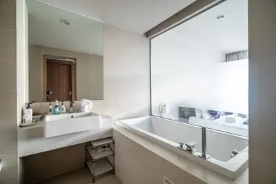 a bathroom with a sink and a large mirror at The Ark at Veloche Group by Lofty in Karon Beach