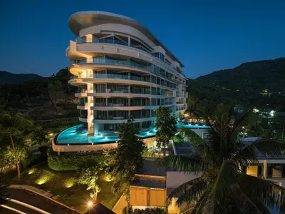 a building with a swimming pool in front of it at The Ark at Veloche Group by Lofty in Karon Beach