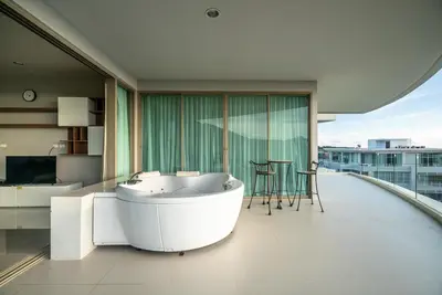 a large bathroom with a tub and a table at The Ark at Veloche Group by Lofty in Karon Beach