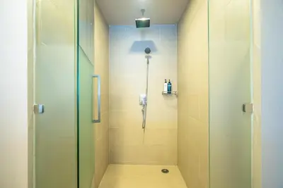 a shower with a glass door in a bathroom at The Ark at Veloche Group by Lofty in Karon Beach