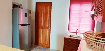 a kitchen with a refrigerator and a window at Новый дом 106 м2, территория 160 м2 и своя парковка in Phuket Town