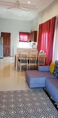 a living room with a couch and a table at Новый дом 106 м2, территория 160 м2 и своя парковка in Phuket Town