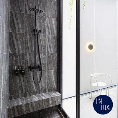 a shower in a bathroom with a stone wall at INNLUXPHUKET in Ban Laem Hin
