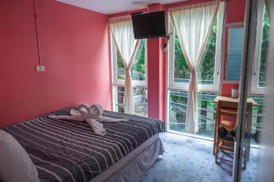 a bedroom with a bed with a stuffed animal on it at Sea Shell Hut in Phi Phi Don