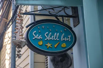 a sign for a sea shell hut on the side of a building at Sea Shell Hut in Phi Phi Don