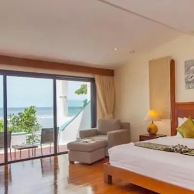a bedroom with two beds and a view of the ocean at Goodwill Beach House in Patong Beach
