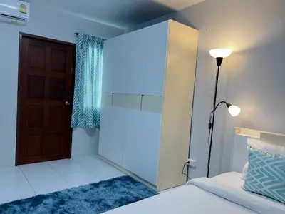 a bedroom with a door and a bed and a lamp at The 4 Blocks at Kata noi in Kata Beach