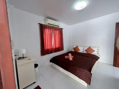 a bedroom with a bed with a red window at The 4 Blocks at Kata noi in Kata Beach