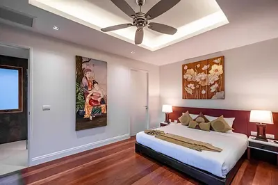 a bedroom with a bed and a ceiling fan at VILLA DIVA STAR in Ko Yao Noi