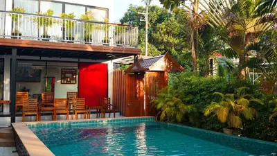 a house with a swimming pool in front of a house at Z&Z House in Rawai Beach