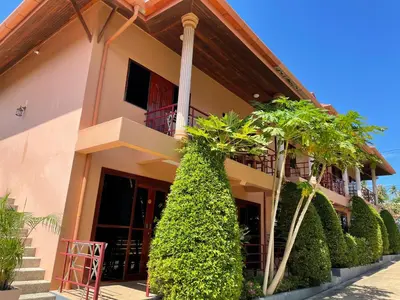 a house with plants in front of it at The Pavillon by The Pace Phuket Boutique Resort in Rawai Beach