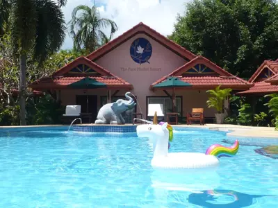 a pool with an inflatable unicorn in front of a resort at The Pavillon by The Pace Phuket Boutique Resort in Rawai Beach