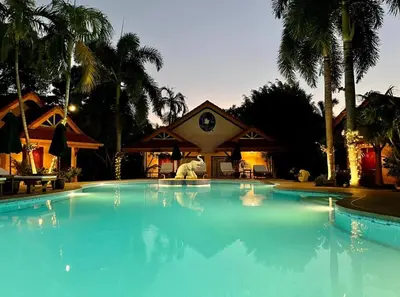 a large blue swimming pool in front of a house at The Pavillon by The Pace Phuket Boutique Resort in Rawai Beach
