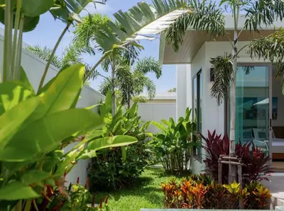 a house with a bunch of plants in front of it at Ananas villa Shambala grand Cherng Talay in Bang Tao Beach