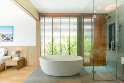 a bathroom with a tub and a glass shower at Ananas villa Shambala grand Cherng Talay in Bang Tao Beach