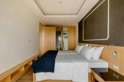 a bedroom with a large bed in a room at The Aristo 2 Condo Surin Beach in Surin Beach