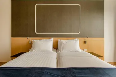 a bedroom with two beds and a board on the wall at The Aristo 2 Condo Surin Beach in Surin Beach