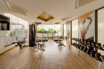 a gym with a lot of treadmills and exercise equipment at The Aristo 2 Condo Surin Beach in Surin Beach