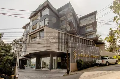 a building with a car parked in front of it at The Aristo 2 Condo Surin Beach in Surin Beach