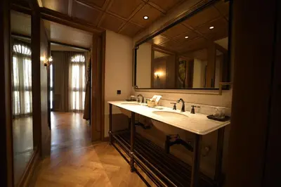 a bathroom with a sink and a large mirror at Hotel Verdigris in Phuket Town