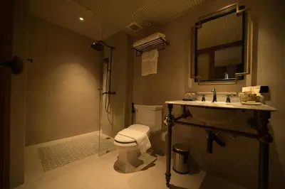 a bathroom with a toilet and a sink and a shower at Hotel Verdigris in Phuket Town