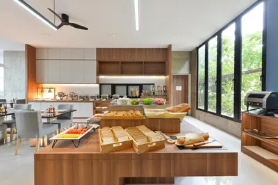 a kitchen with a table with food on it at Grace Patong Hotel in Patong Beach