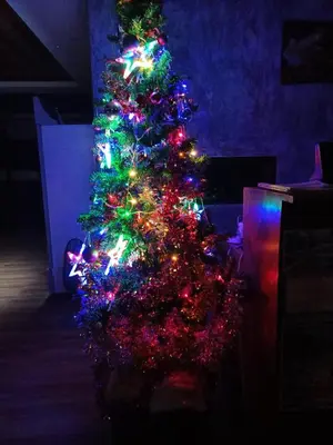 a christmas tree decorated with lights in a room at The mantra resort in Ko Yao Yai