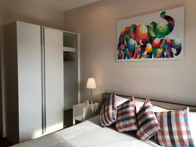 a bedroom with a bed and a painting on the wall at The Title West Wing@Rawai By Siri in Rawai Beach
