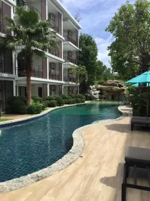 a swimming pool in front of a building at The Title West Wing@Rawai By Siri in Rawai Beach