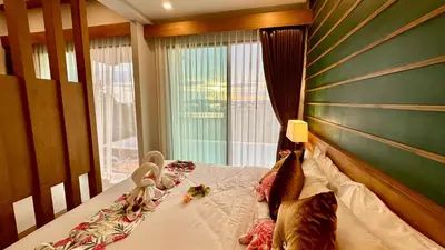 a bedroom with a bed with a large window at Aonang Phu Dahla Private Pool & Sea View - SHA Plus in Ao Nang Beach