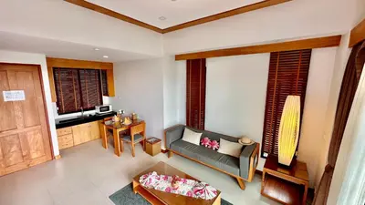 a living room with a couch and a table at Aonang Phu Dahla Private Pool & Sea View - SHA Plus in Ao Nang Beach