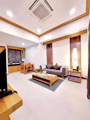 a living room with a couch and a table at Aonang Phu Dahla Private Pool & Sea View - SHA Plus in Ao Nang Beach