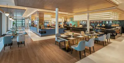 a restaurant with tables and chairs and a bar at Hyatt Regency Phuket Resort in Kamala Beach